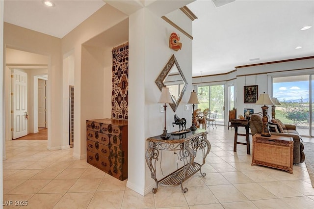 hall with recessed lighting, baseboards, crown molding, and light tile patterned floors