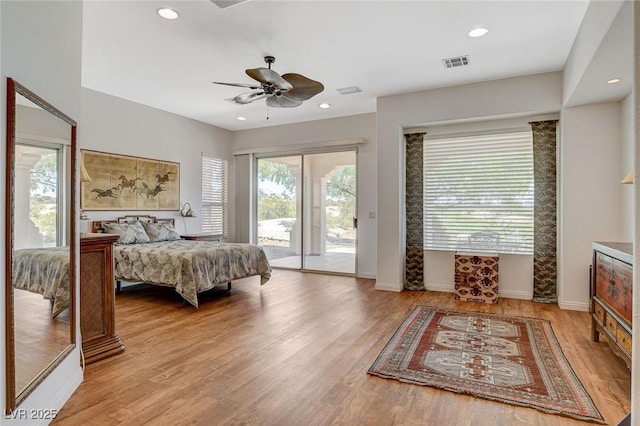 bedroom featuring access to outside, baseboards, visible vents, and light wood-style flooring