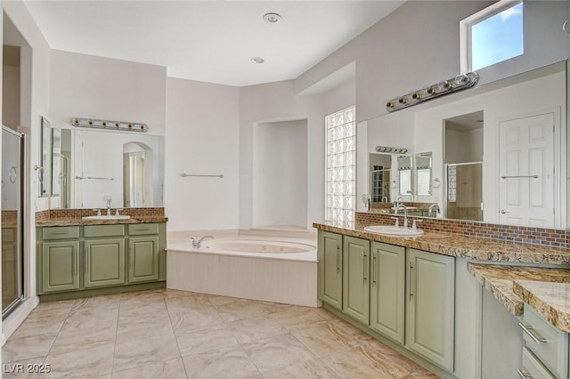 full bath with a garden tub, a sink, a stall shower, and a wealth of natural light
