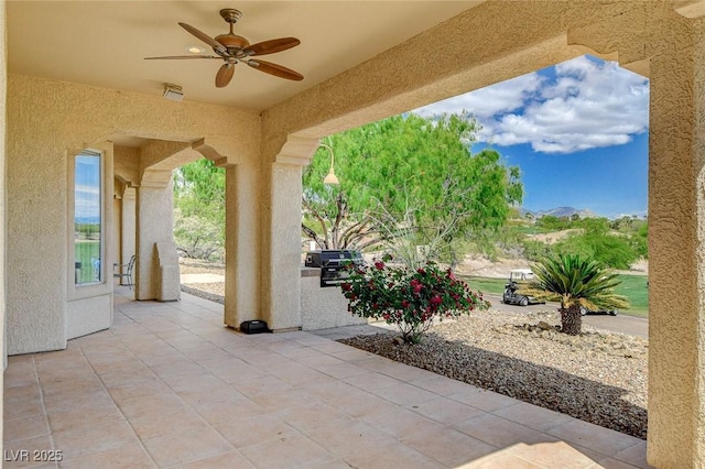 view of patio featuring ceiling fan