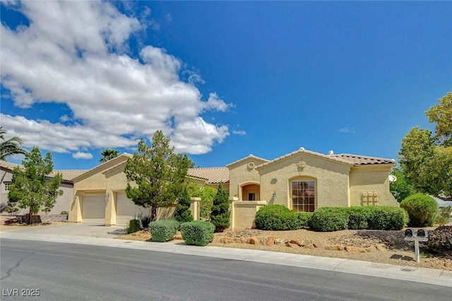 mediterranean / spanish-style home with stucco siding, a tiled roof, driveway, and a garage