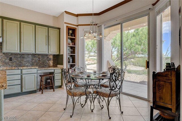 dining room featuring light tile patterned floors, built in shelves, and a chandelier