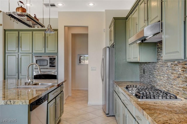 kitchen featuring a sink, appliances with stainless steel finishes, green cabinetry, and under cabinet range hood