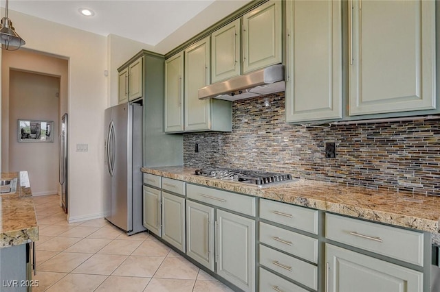 kitchen with light tile patterned floors, stainless steel appliances, decorative backsplash, and under cabinet range hood
