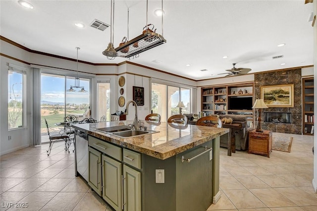 kitchen with crown molding, a ceiling fan, light tile patterned flooring, green cabinetry, and a sink