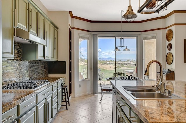 kitchen with light tile patterned flooring, a sink, stainless steel appliances, backsplash, and pendant lighting