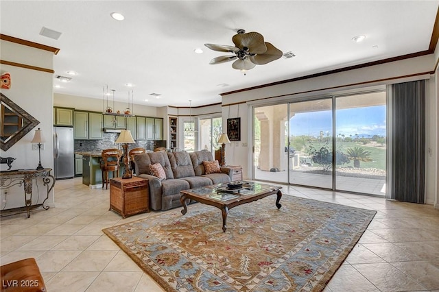 living area featuring light tile patterned flooring, ceiling fan, recessed lighting, and ornamental molding