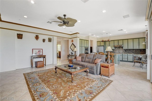 living area with visible vents, a ceiling fan, light tile patterned flooring, and recessed lighting