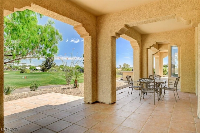 view of patio featuring view of golf course and outdoor dining space