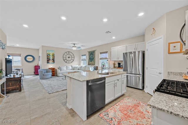 kitchen featuring visible vents, white cabinets, a sink, appliances with stainless steel finishes, and a wealth of natural light