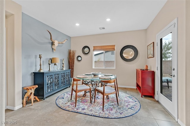 dining space with baseboards, visible vents, and a healthy amount of sunlight