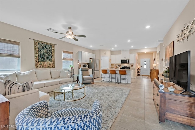 living area with visible vents, recessed lighting, ceiling fan, and light tile patterned floors