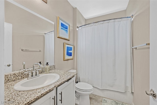 bathroom with vanity, tile patterned flooring, shower / bath combo with shower curtain, and toilet