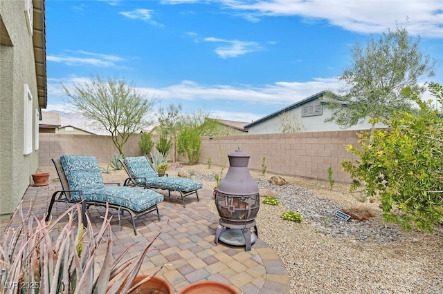 view of patio / terrace featuring a fenced backyard and an outdoor fire pit