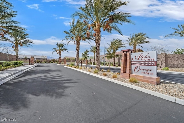view of street featuring curbs and a gated entry