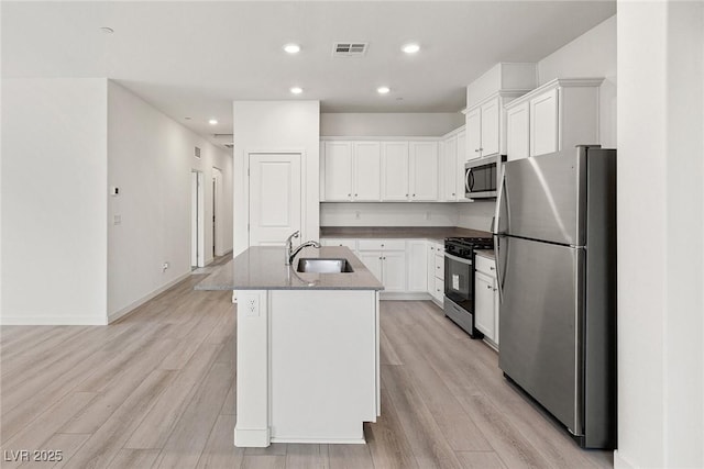2733 Avril Point St, Las Vegas, NV 89156 - kitchen featuring a sink, a kitchen island with sink, stainless steel appliances, and light wood finished floors