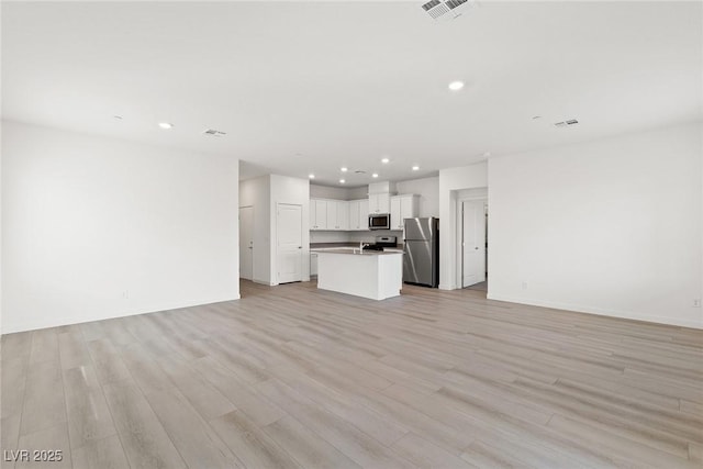 2733 Avril Point St, Las Vegas, NV 89156 - unfurnished living room featuring baseboards, light wood-type flooring, recessed lighting, and visible vents