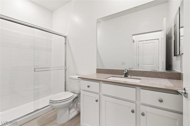 2733 Avril Point St, Las Vegas, NV 89156 - bathroom with wood finished floors, a stall shower, toilet, and vanity