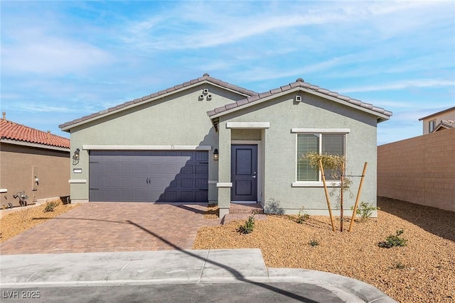2733 Avril Point St, Las Vegas, NV 89156 - ranch-style home with decorative driveway, a garage, fence, and stucco siding