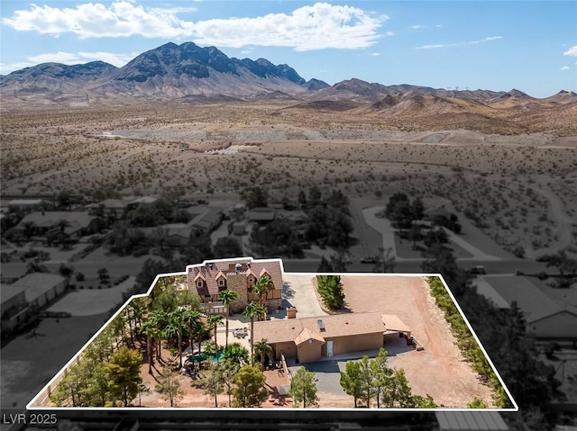 birds eye view of property with a mountain view