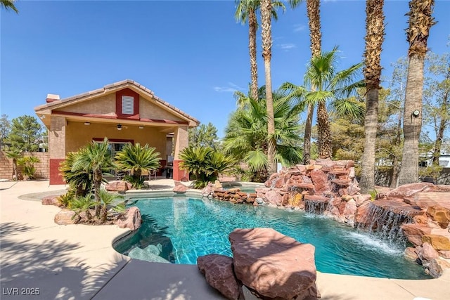 pool with a patio and an in ground hot tub