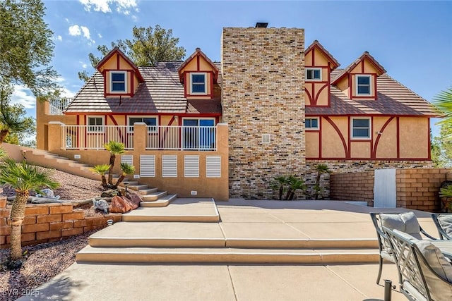 rear view of property with stucco siding