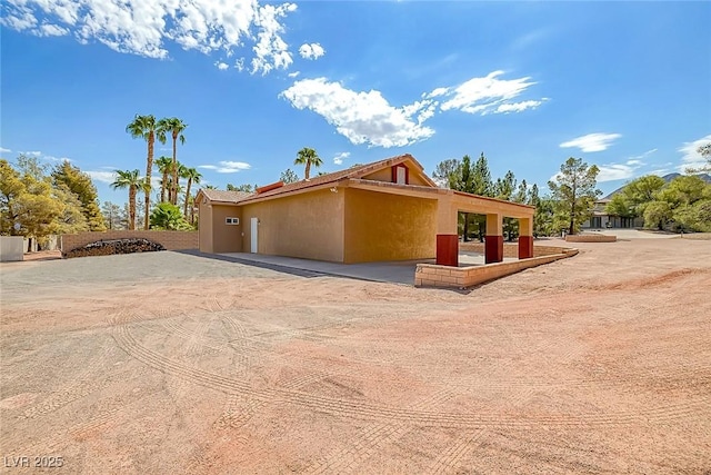 view of side of home with stucco siding