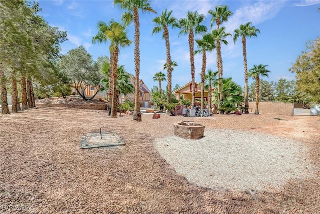 view of yard with a fire pit