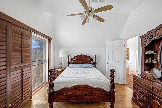 bedroom featuring light wood-style floors, a ceiling fan, and lofted ceiling
