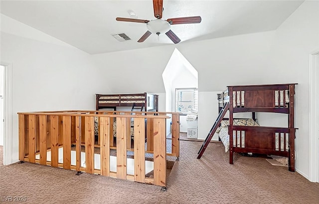 carpeted bedroom featuring baseboards, lofted ceiling, and visible vents