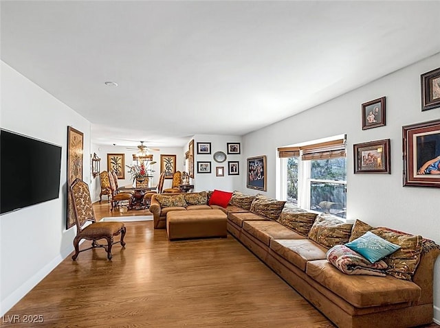living room with a ceiling fan and wood finished floors