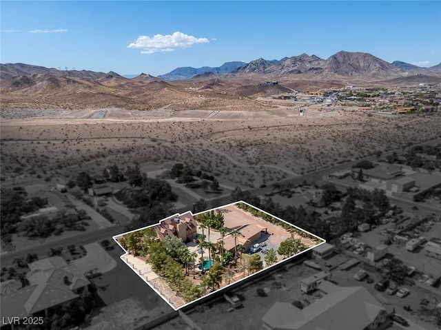 birds eye view of property featuring a desert view and a mountain view