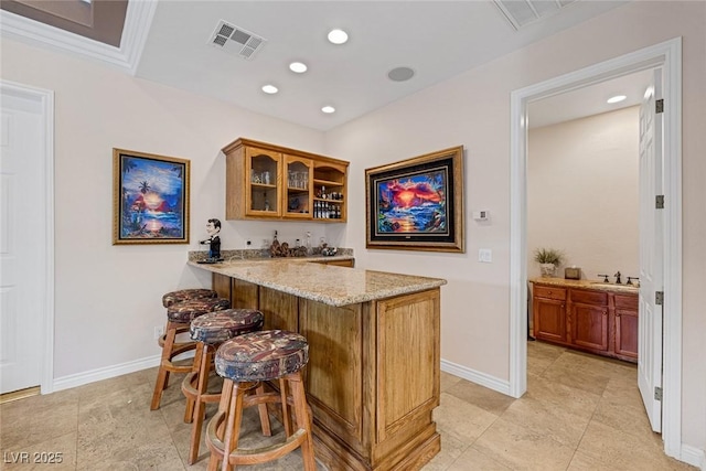 bar featuring baseboards, indoor bar, recessed lighting, and visible vents