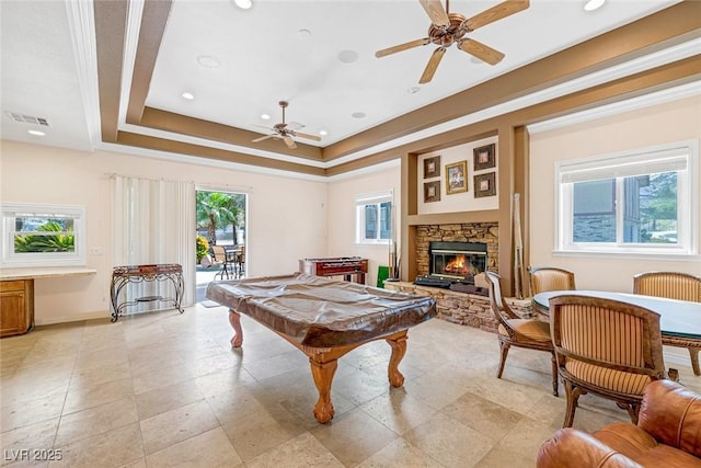 recreation room with ceiling fan, a raised ceiling, a fireplace, pool table, and visible vents