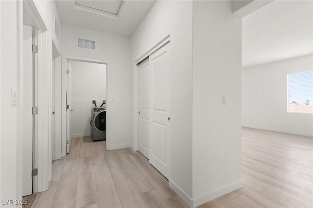 2739 Avril Point St, Las Vegas, NV 89156 - hallway featuring light wood-type flooring, baseboards, washer / clothes dryer, and visible vents
