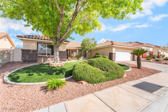 ranch-style home with a garage, stucco siding, a tile roof, and concrete driveway