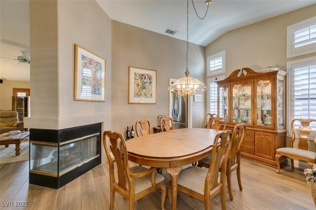 dining area featuring a healthy amount of sunlight, light wood-type flooring, and visible vents