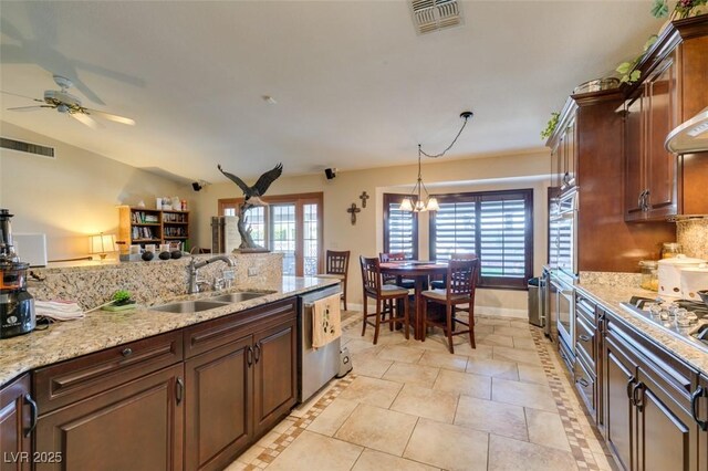 kitchen featuring a sink, appliances with stainless steel finishes, ceiling fan with notable chandelier, and visible vents