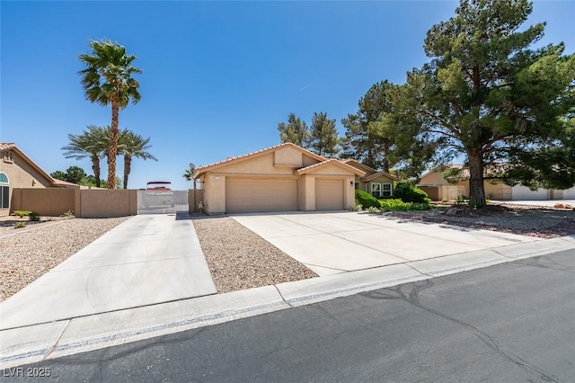 single story home with driveway, a gate, a garage, fence, and stucco siding