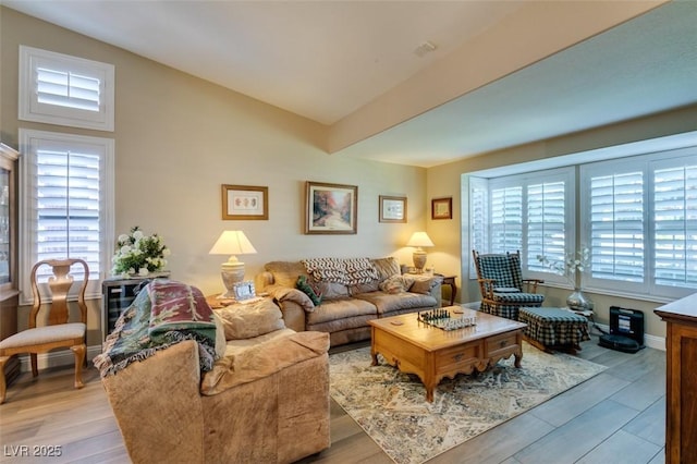 living area featuring light wood-style flooring and lofted ceiling