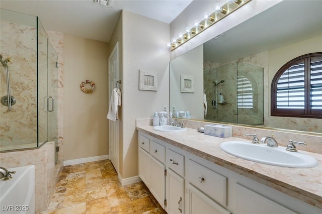 full bath featuring double vanity, a sink, a bath, and a shower stall