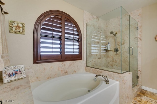 full bathroom featuring a shower stall and a garden tub