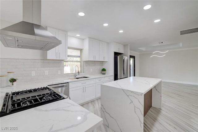 kitchen with island range hood, a center island, recessed lighting, a sink, and stainless steel appliances