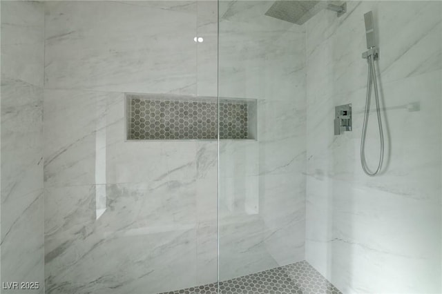 full bathroom with a marble finish shower
