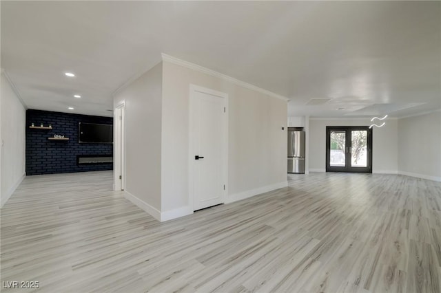 interior space featuring crown molding, light wood finished floors, and baseboards