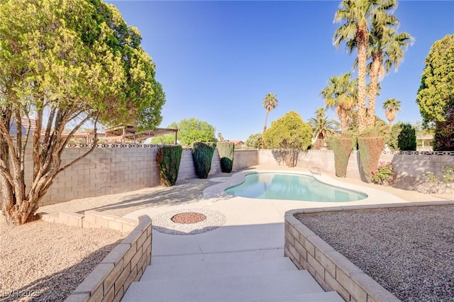 view of pool with a fenced in pool, a fenced backyard, and a patio area