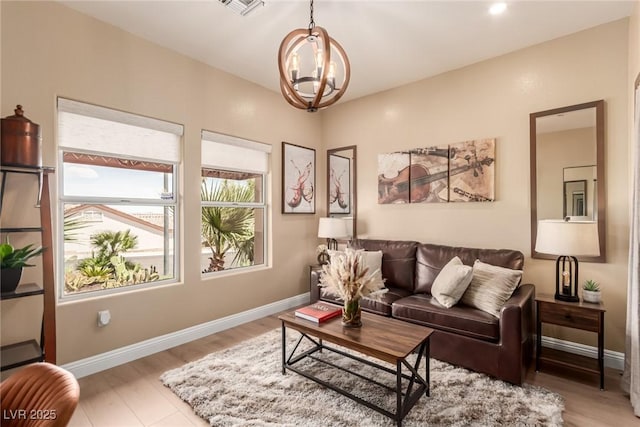 10713 Shoalhaven Dr, Las Vegas, NV 89134 - living area with a chandelier, light wood-style floors, and baseboards