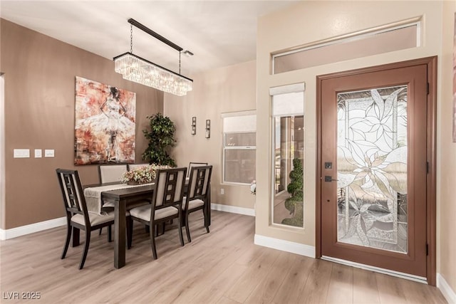 10713 Shoalhaven Dr, Las Vegas, NV 89134 - dining space featuring a chandelier, wood finished floors, and baseboards