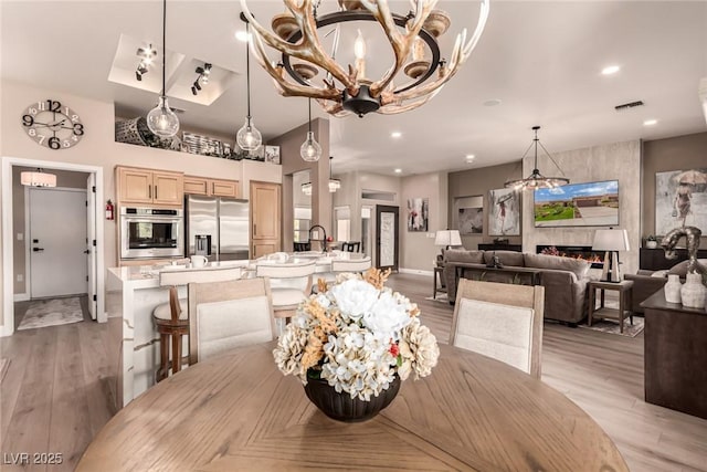 10713 Shoalhaven Dr, Las Vegas, NV 89134 - dining room with light wood-type flooring, a chandelier, baseboards, and recessed lighting