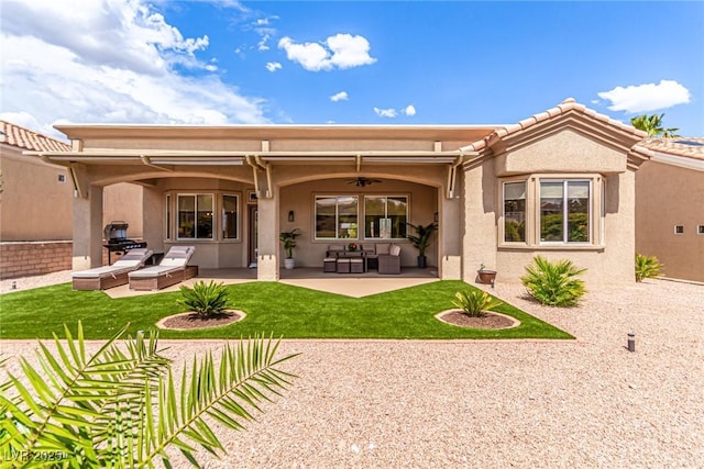 10713 Shoalhaven Dr, Las Vegas, NV 89134 - back of house with ceiling fan, a patio area, a lawn, and stucco siding